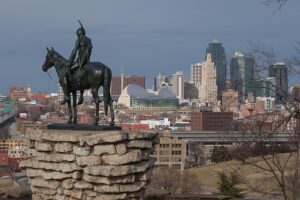 The Scout statute on stone pedestal on left of image. Downtown Kansas City in the distance to the right. Photo by Benjamin White 